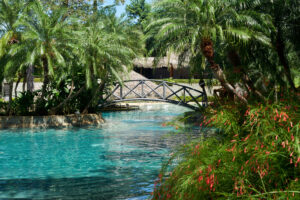 explore the gardens and pools at this tamarindo surf camp resort or Tamarindo Vacation Package resort