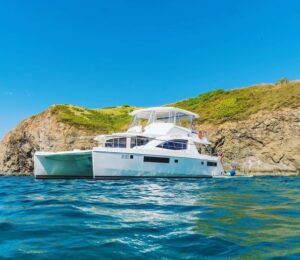 a 51 foot white yacht prepares to take off with guests for a full day witch's rock boat trip in Costa Rica