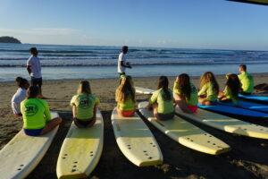 Director of Surf, Jairo Zuniga, gives the first part of the surf lesson on land in Costa Rica at the samara surf camp