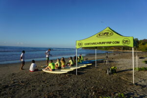 Professional surf instructors introduce students to their equipment, area, and safety concerns on land before the surf lesson in Costa Rica with Costa Rica Surf Trip!