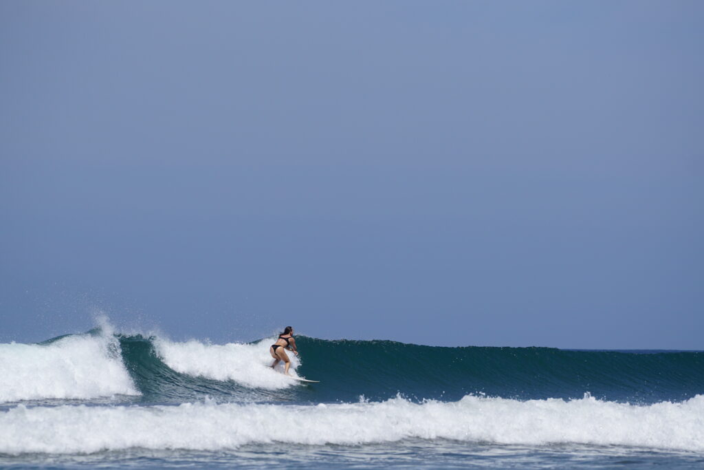 Riding a left handed wave in Playa Guiones Nosara with Costa Rica Surf Trip