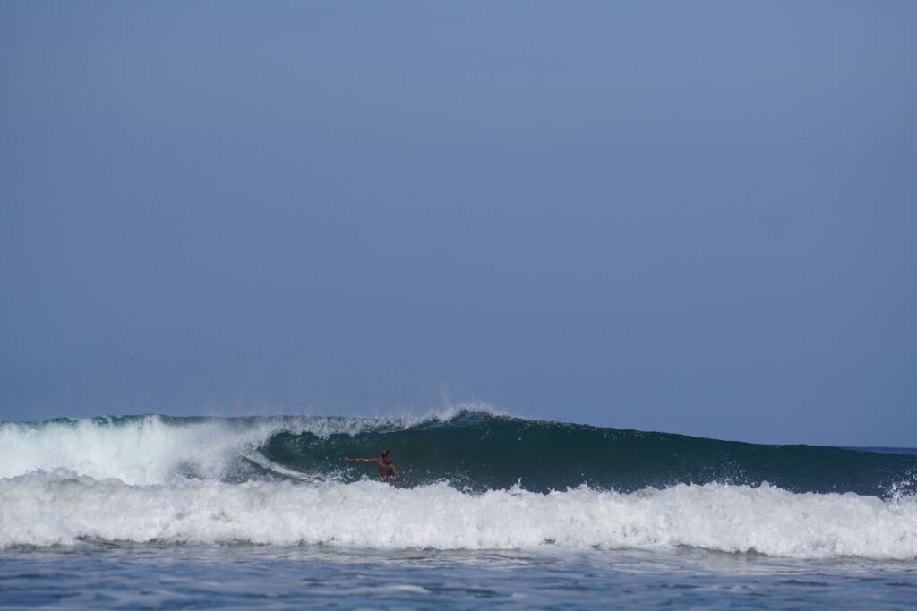 Dropping into the wave in Guiones Nosara
