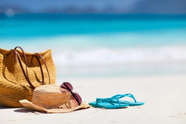 flip flops and sun hat on the beach