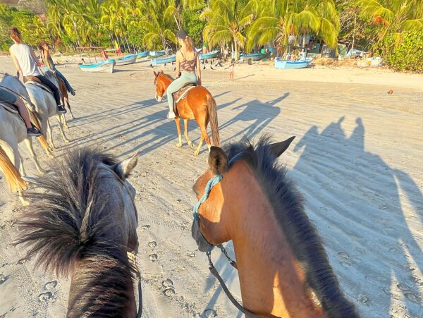 horseback riding on the beach in costa rica at the Guiones Nosara Surf & Yoga camp